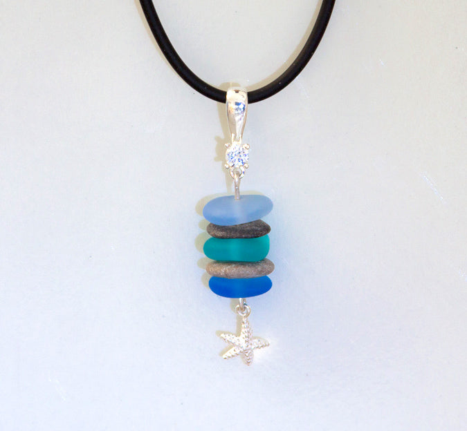 Beach glass pendant with Lake Michigan beach stones, silver starfish, silver cubic zirconia bail on a black cord necklace.