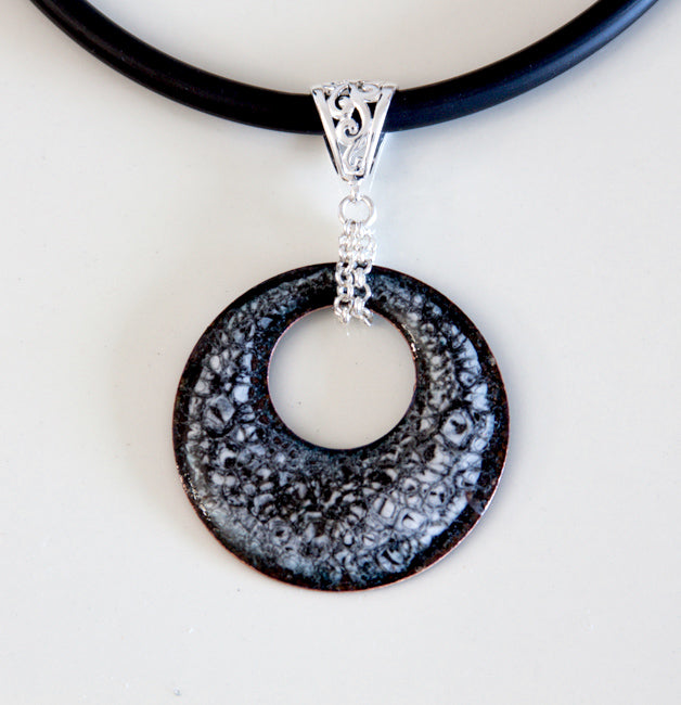 Black and grey speckled round enamel necklace with silver bail and black rubber cord