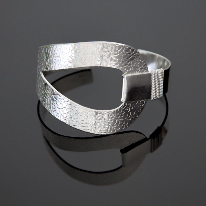Sterling silver cuff bracelet with embossed flower pattern