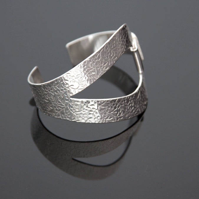 Sterling silver cuff bracelet with embossed flower pattern