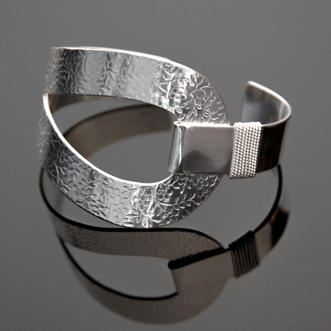 Sterling silver cuff bracelet with embossed flower pattern