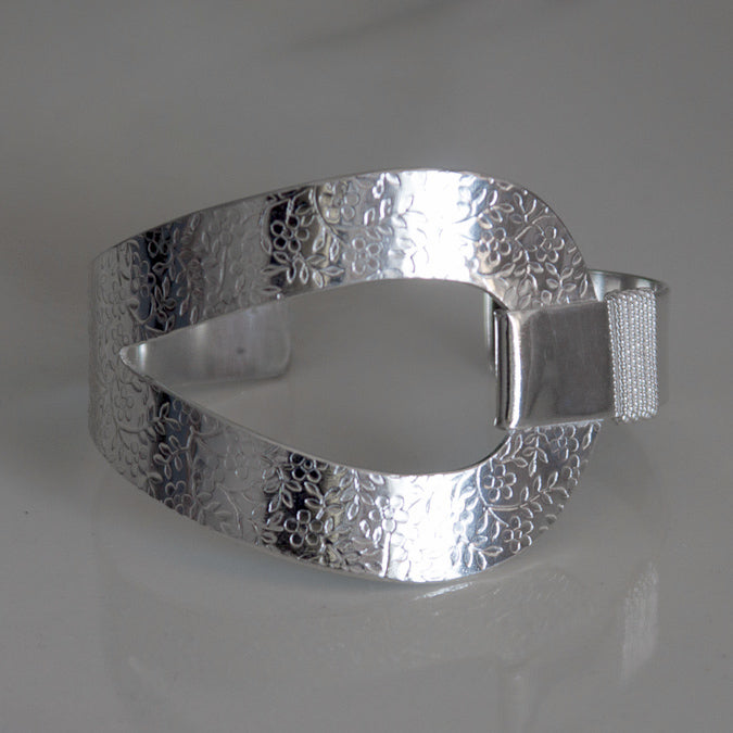 Sterling silver cuff bracelet with embossed flower pattern
