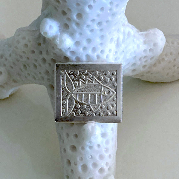 silver handmade golf ball marker slightly rectangular with engraved folk art fish and bubbles