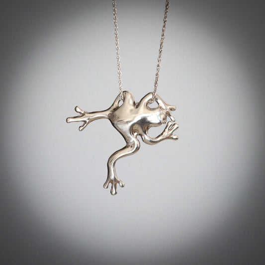 "Hang In There" Frog Necklace made of sterling silver and hangs by one front arm and one back leg from a sterling silver chain.
