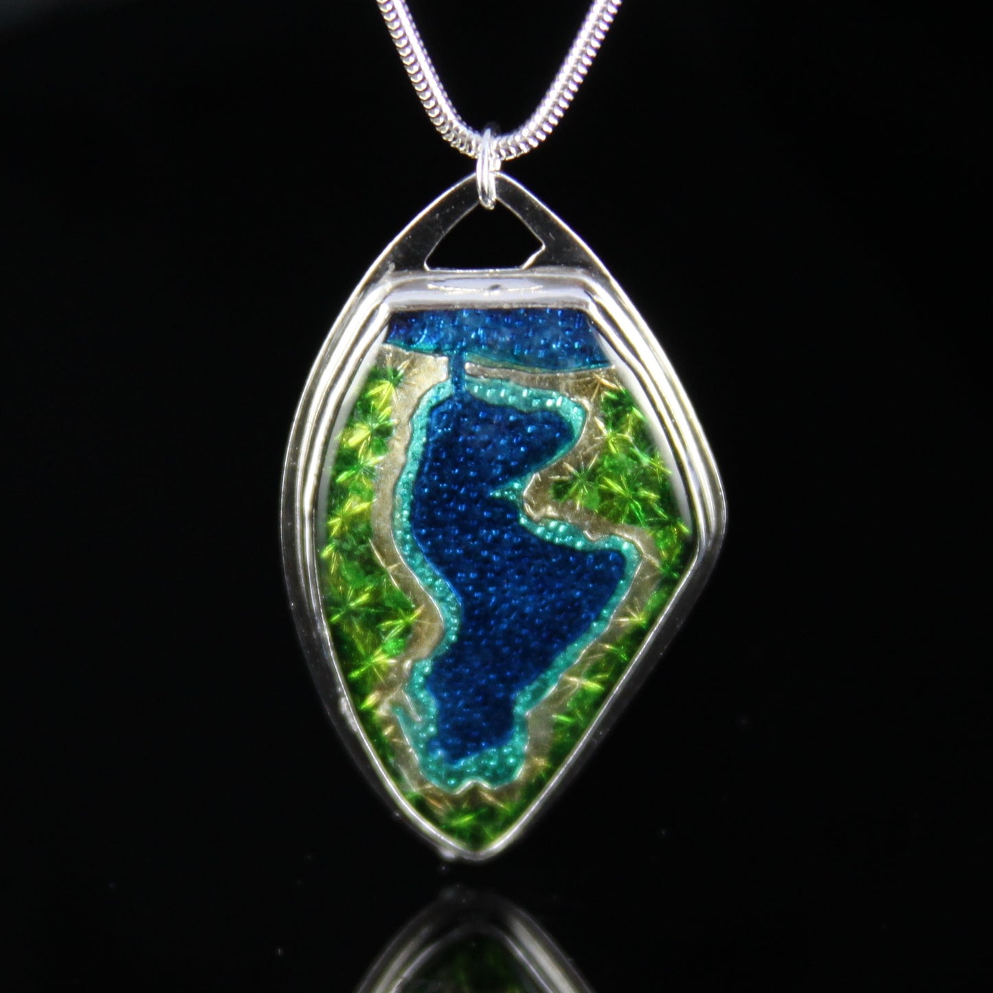 Enamel pendant of Portage Lake in Onekama, Michigan. Pendant is set in fine silver.