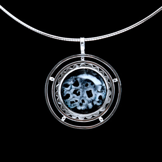 Solar Eclipse is a handmade, black gray and white enamel pendant necklace set in fine silver