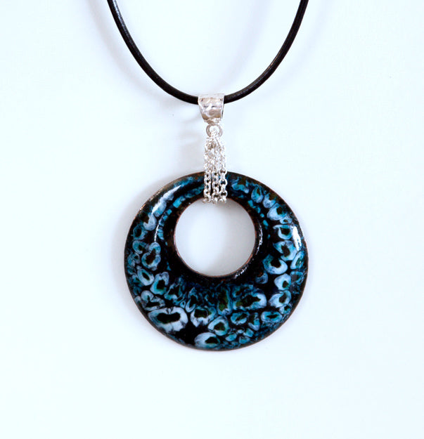 Black, turquoise and white round enamel pendant with silver bail. Hung from black leather cord.