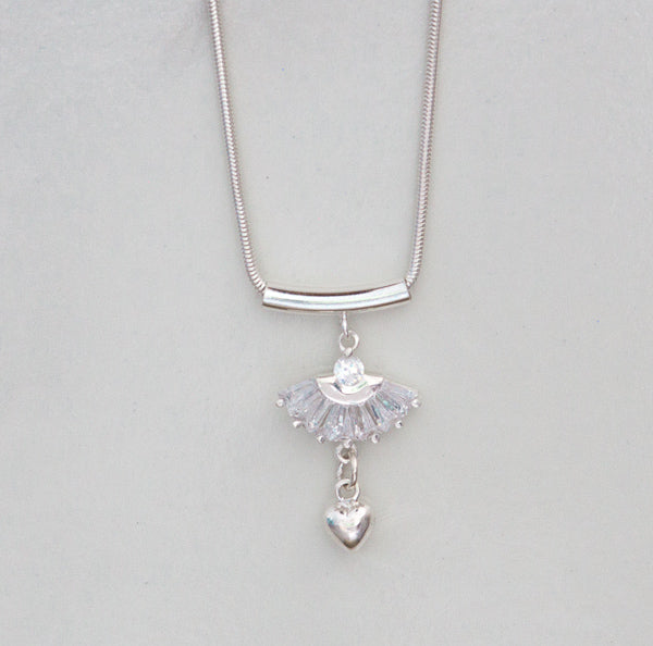 Angel In Your Heart silver pendant resembles an angel's dress with full organza skirt. A silver heart hangs from the bottom.