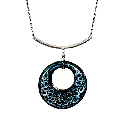 Turquoise, black and white enamel pendant on silver curved bail with white background