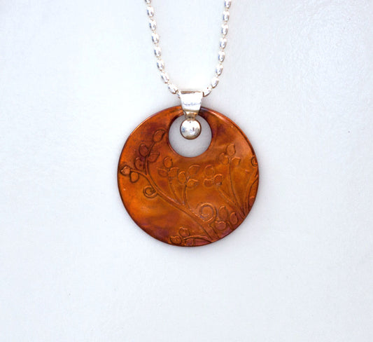 Field of Hope round copper pendant necklace embossed with field stems and leaves with silver bail and chain