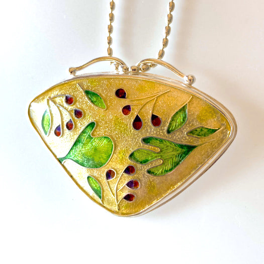 Enamel cloisonné pendant with sassafras leaves, red and purple berries, and a golden background. Set in fine silver